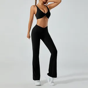 Vue complète d'un ensemble de yoga noir avec pantalon évasé et brassière nouée