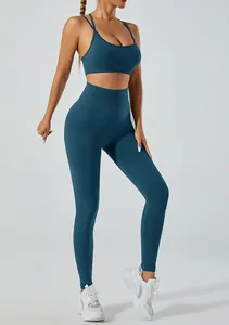 Detail view of teal high-waist yoga set with cross-back sports bra and leggings.
