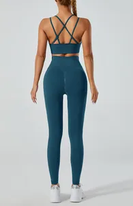 Back view of teal yoga set featuring cross-back sports bra and high-waist leggings