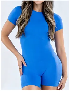 Detailed view of a bright blue high-stretch short-sleeved yoga bodysuit on a model