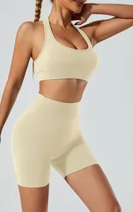 Detailed view of seamless beige high-waist yoga shorts and halter sports bra set.