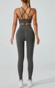 Back view of gray yoga set featuring cross-strap sports bra and high-waist leggings