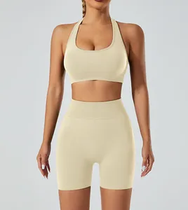 Front view of seamless high-stretch beige yoga set with halter sports bra and shorts