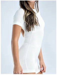 Close-up of white backless short sleeve yoga bodysuit showing slim fit and fabric texture