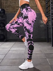 Professional detail view of pink tie-dye high waisted yoga leggings in gym setting