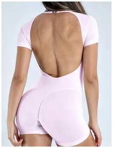 Close-up view of backless pink yoga bodysuit with short sleeves and lift-up design