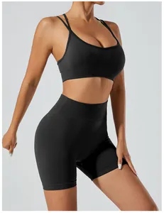 Professional view of woman wearing seamless black high-waisted yoga shorts and sports bra