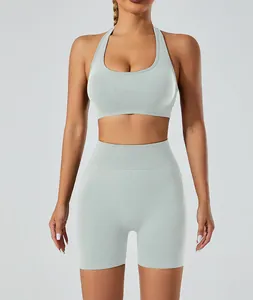Detailed view of seamless high-waist yoga shorts and halter sports bra set in mint green.