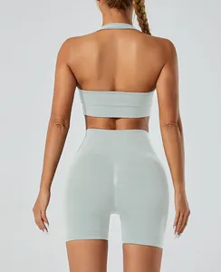 Back view of seamless high-waisted yoga shorts and halter sports bra in mint green