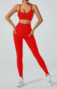 Vibrant red yoga set featuring a backless sports bra and high-waisted workout leggings
