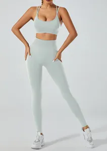Close-up of a seamless mint green yoga set with high-waist leggings and a strappy sports bra.
