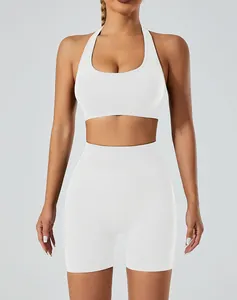 Detail view of seamless white halter-neck sports bra and high-waist yoga shorts set