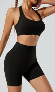 Detail view of black seamless high-stretch yoga set showing sports bra and high-waist shorts.