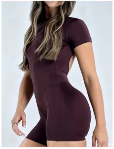 Close-up of a high-neck burgundy yoga jumpsuit with backless design and short sleeves