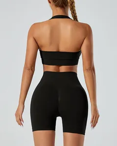 Back view detail of seamless black yoga set with halter neck sports bra and shorts