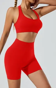 Professional close-up of red seamless high-waisted yoga shorts and matching halter sports bra