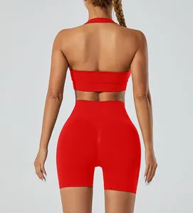 Back view of a red seamless halter yoga sports bra and high-waist fitness shorts set.