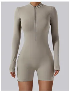 Front view of long sleeve zip-up yoga bodysuit in greige with athletic fit design