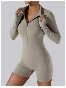 Detail view of a zip-up long sleeve yoga romper showing the slim fit and fabric texture.