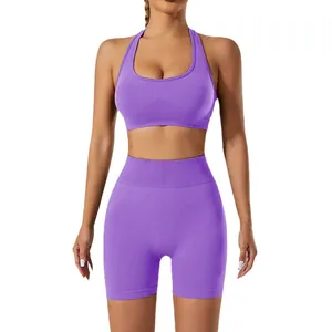 Vibrant purple two-piece seamless yoga set with halter sports bra and high-waist shorts.