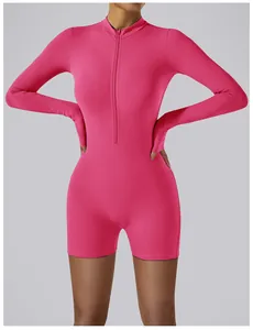 Front view of a hot pink long-sleeve yoga bodysuit with zipper closure and slim fit