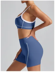 Side profile of high waist blue yoga shorts and matching sports bra with white piping