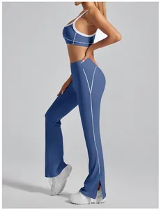 Side view of blue yoga flare pants with white piping and leg slits detail.