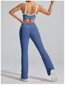 Back view of high waisted blue flared yoga pants with white trim for gym workout and dance