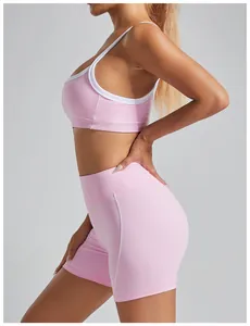 Side view of pink high-intensity sports bra with white trim and matching shorts