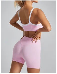 Back view of pink sports bra with white trim and matching high-waisted shorts