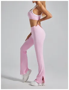 Detail view of pink flared yoga pants with high waist and side split hem for women