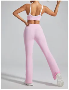 Back view of pink yoga flare pants and matching sports bra showing slim fit design.