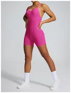 Detailed side view of the fuchsia seamless backless yoga bodysuit for women in studio