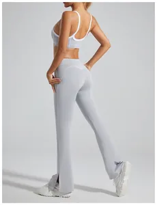 Professional detail view of grey high-waist flared yoga pants with split hem design