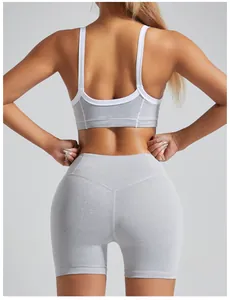 Detailed back view of a grey sports bra with white trim and matching gym leggings