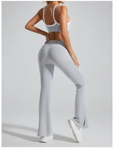 High-waisted grey flared yoga pants with side split hem showing back view and slim fit