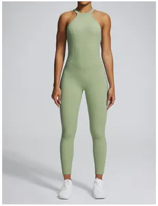 Front view of a green halter neck backless yoga jumpsuit for fitness and exercise.