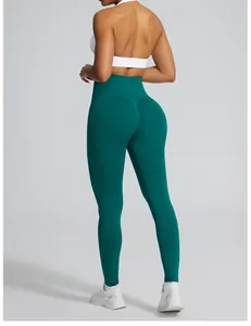 Rear view of dark green seamless high-waist yoga leggings with peach butt design