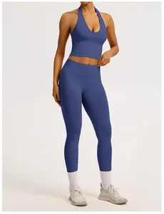 Women's blue seamless yoga set featuring halter neck sports bra and ribbed leggings