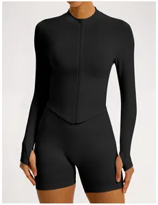 Close-up of black seamless ribbed long-sleeve yoga top with zipper and thumbholes