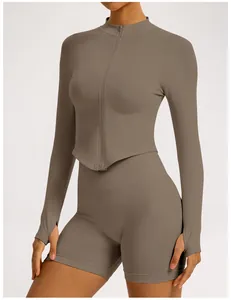Detail of seamless taupe yoga set with zip-up jacket and ribbed high-waist shorts.