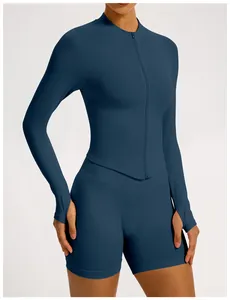 Detail view of navy blue seamless yoga set featuring long sleeve zip-up top and shorts.