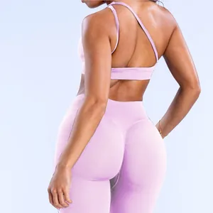 Detailed back view of pink seamless sports bra with cross-straps and high-waist leggings