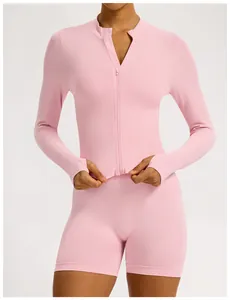 Front detail view of a pink seamless long sleeve yoga set with zip-up top and shorts