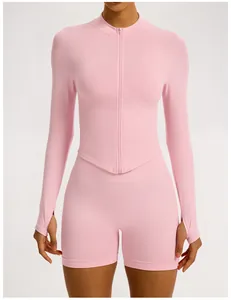 Front view of pink seamless ribbed yoga set with long sleeve zipper top and shorts