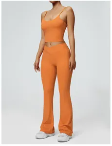 Close-up of vibrant orange yoga set featuring padded camisole and flared pants