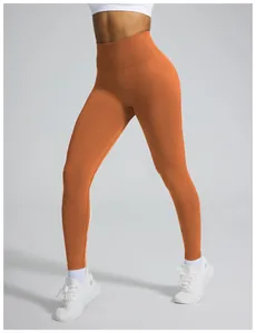 Detailed view of seamless orange high-waisted leggings showing texture and peach lift design