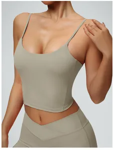 Close-up detail of a sage green spaghetti strap yoga tank top with matching leggings.