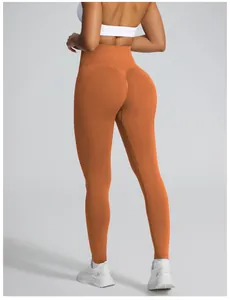 High-waisted seamless peach butt yoga leggings in vibrant orange for gym fitness
