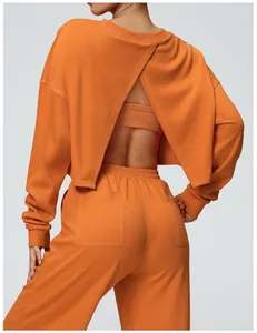 Rear view of women's orange cropped cross-back sweatshirt and matching joggers set